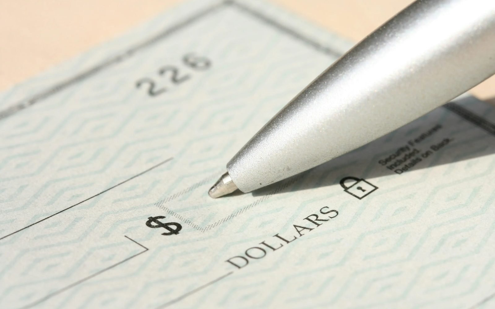 Pen resting on a signed financial document